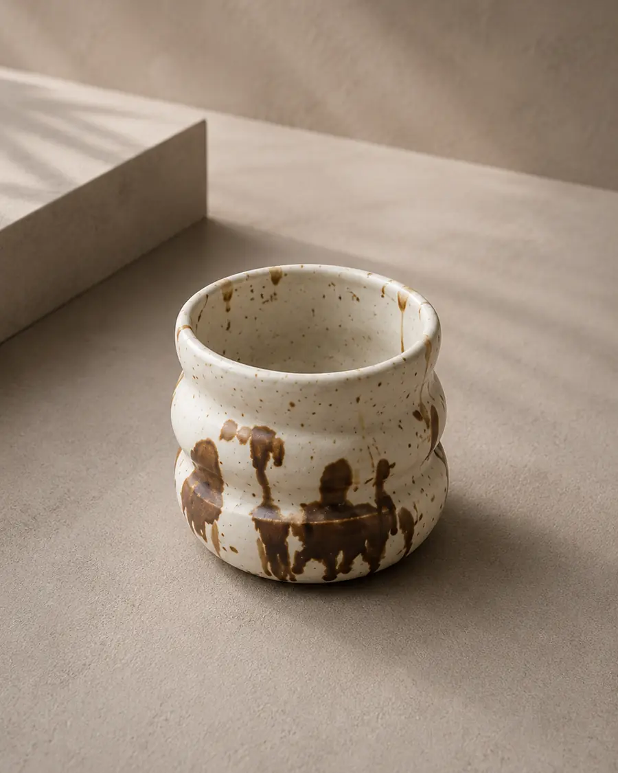 Cup in pale clay with warm brown splatter glaze