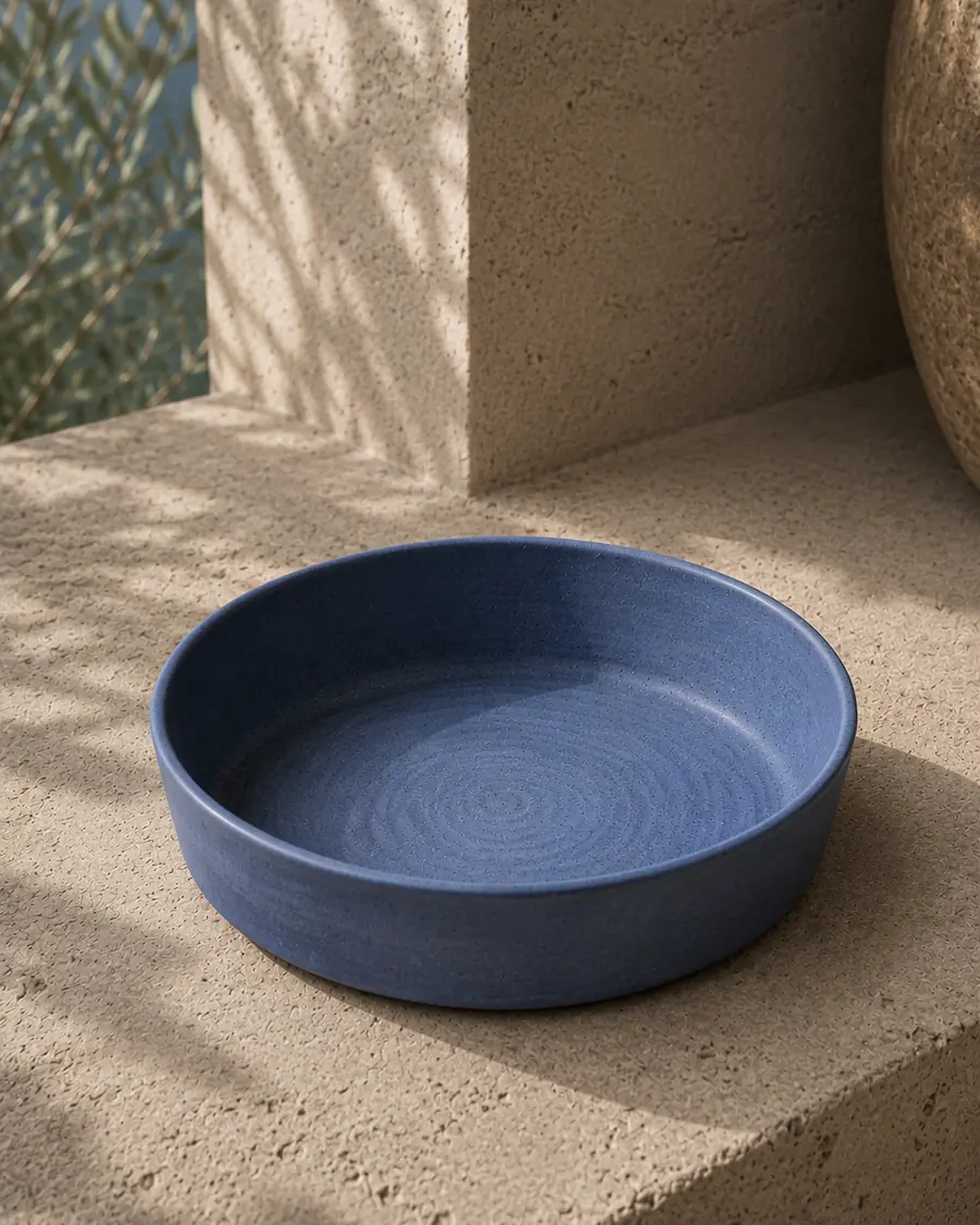 Deep blue serving dish on a stone ledge