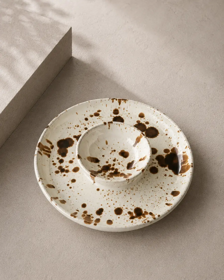 Splatter-glazed platter with a central dipping bowl